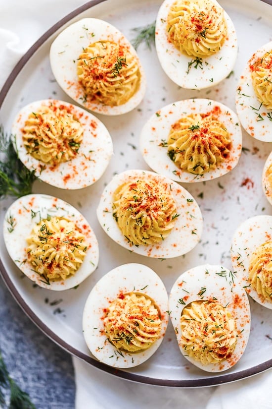 Made with mayo, dijon mustard, and paprika, these Classic Deviled Eggs are an easy and flavorful side dish or appetizer! Deviled eggs on a serving platter