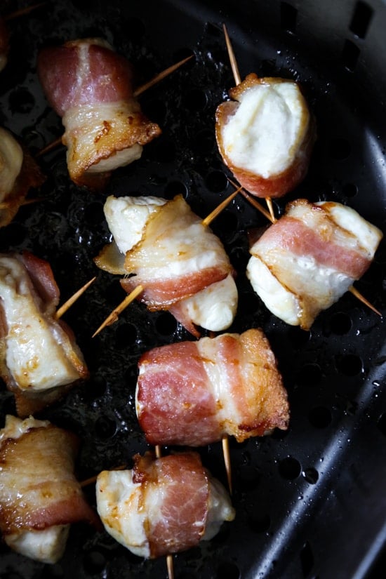 Bacon wrapped chicken bites are the easiest appetizer, made with just TWO ingredients. Using the air fryer, the bacon comes out crisp on the outside, and the chicken juicy and tender inside.