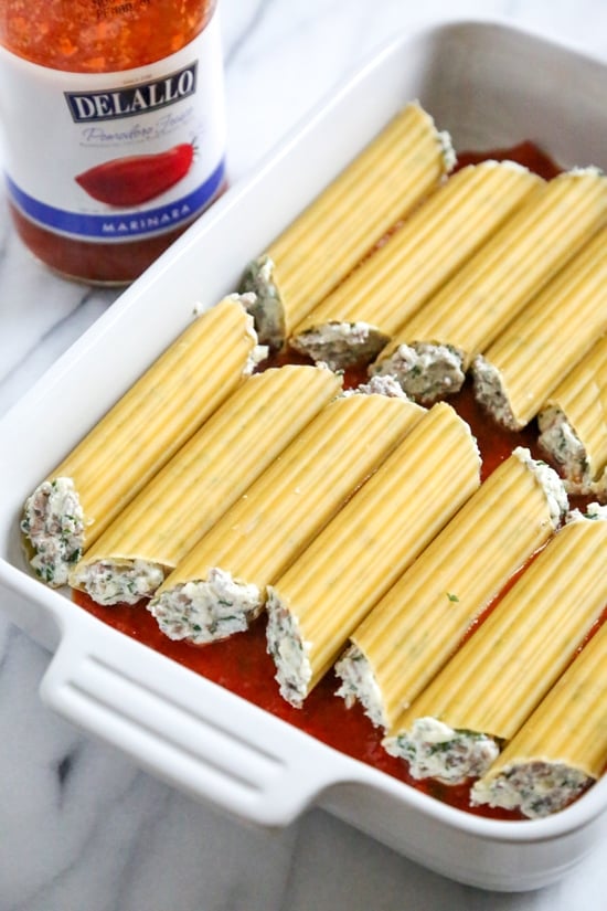 This easy no-boil baked manicotti pasta dish, known as Cannelloni is stuffed with ricotta, parmesan, mozzarella and lean ground beef, then covered in sauce and cheese. Perfect for the holidays, for to bring to a potluck or to enjoy any night of the week!