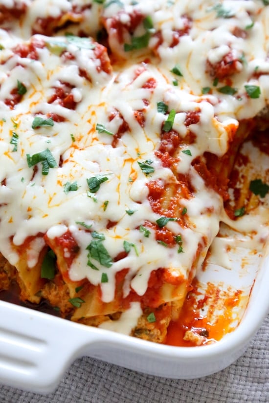 This easy no-boil baked manicotti pasta dish, known as Cannelloni is stuffed with ricotta, parmesan, mozzarella and lean ground beef, then covered in sauce and cheese. Perfect for the holidays, for to bring to a potluck or to enjoy any night of the week!