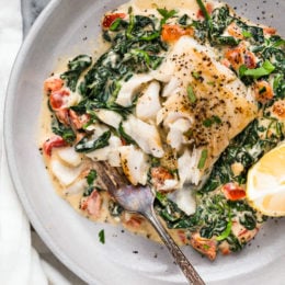 This easy Fish Florentine recipe, made with a pan seared firm white fish served on a creamy bed of spinach feels like something you would order out in a fancy restaurant!