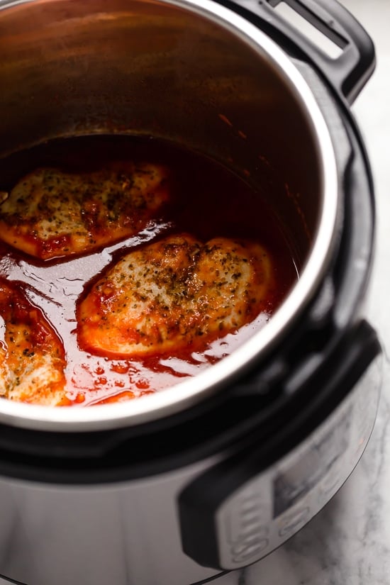 This quick and easy Instant Pot Chicken Parmesan is ready in minutes, with no breading or frying. Perfect for busy weeknights! Chicken parmesan in the Instant Pot