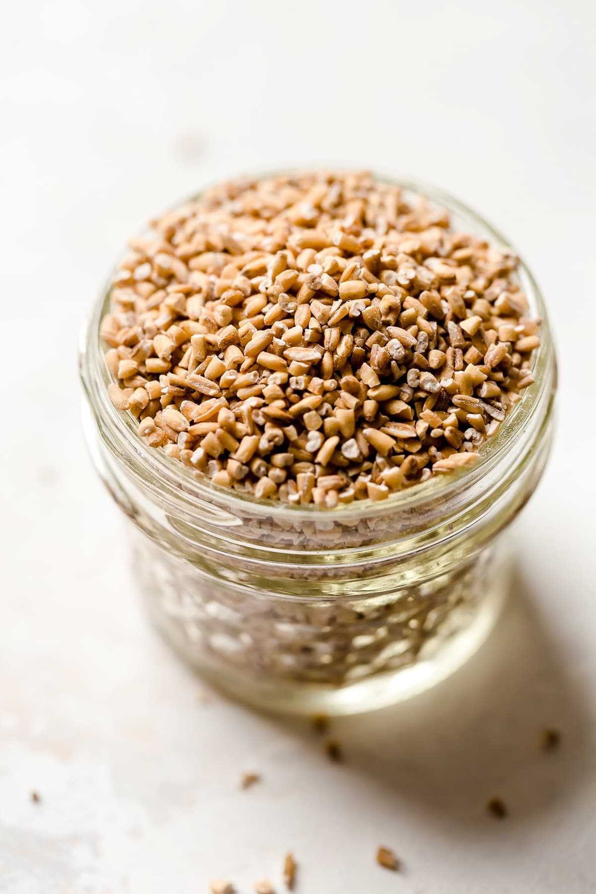 Instant Pot steel cut oats are so much faster than making them on the stove! Learn how to cook steel cut oats for a warm, hearty breakfast. A mason jar of steel cut oats