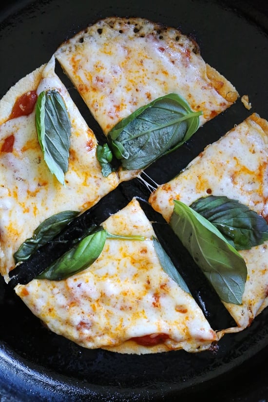 I'm obsessed with this Super-Quick Cast-Iron Pizza technique made with tortillas.This combined stove top and oven recipe comes out just like Domino's or any bar thin crust pizza!