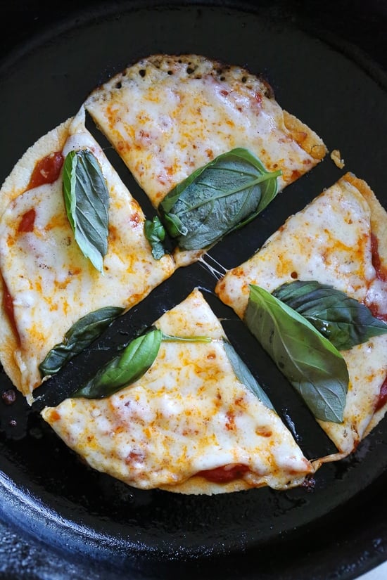 I'm obsessed with this Super-Quick Cast-Iron Pizza technique made with tortillas.This combined stove top and oven recipe comes out just like Domino's or any bar thin crust pizza!