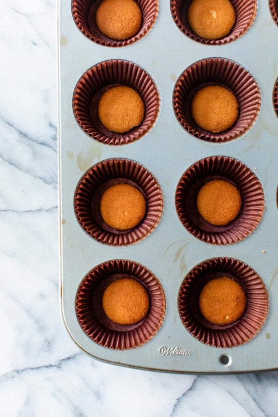 line cupcake tins and place a vanilla wafer in each one.