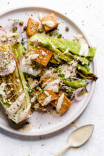 Vegan Caesar salad on plate with creamy dressing.