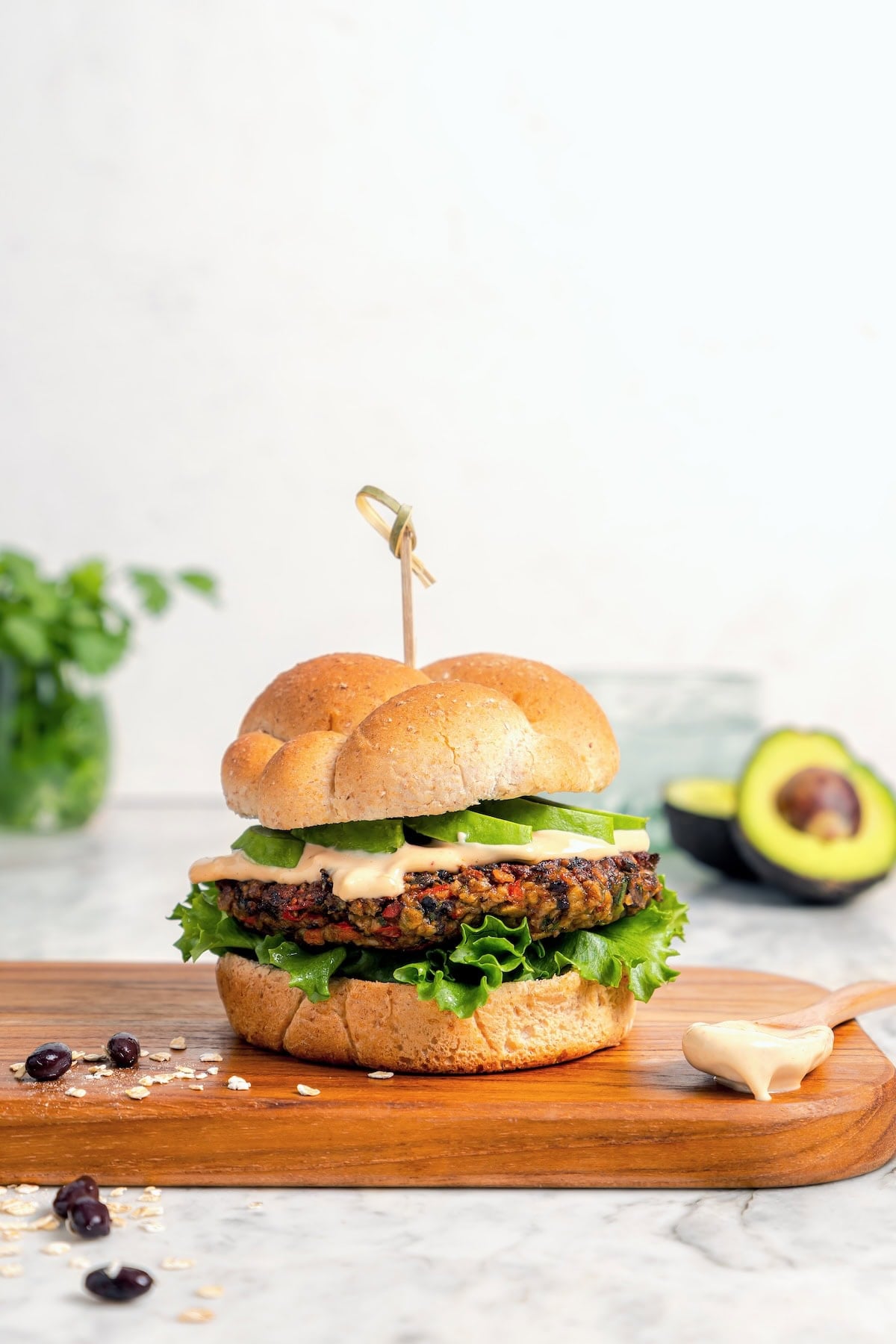 These black bean burgers are flavorful, satisfying and easy to make ahead. With a smoky chipotle mayo and avocado on top, they're delicious! Veggie burger on a wood cutting board