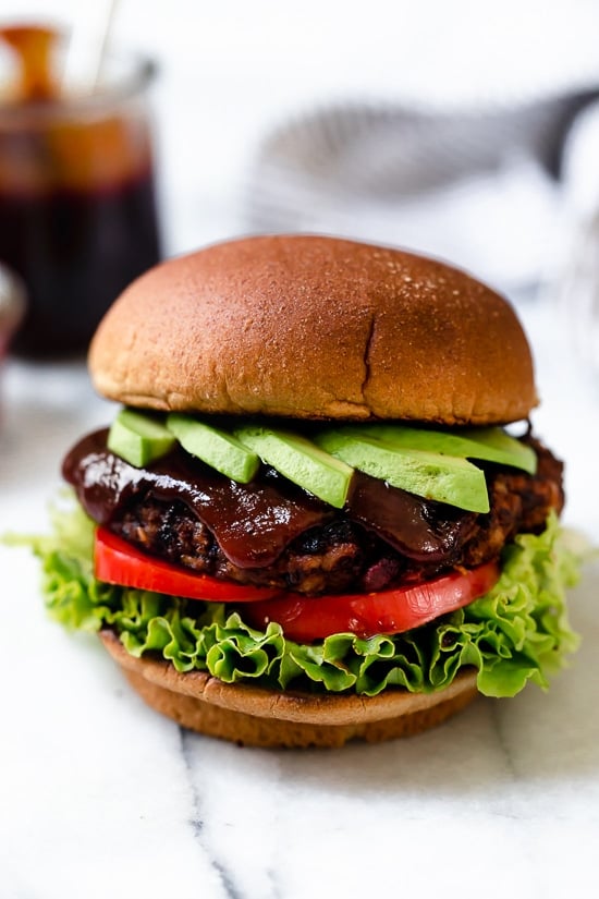 Made with beans and grains, this veggie burger recipe is hearty and satisfying, and the seasonings make it a standout. Perfect for freezing! Copycat Houston's veggie burger topped with avocado, lettuce, tomato, and BBQ sauce.