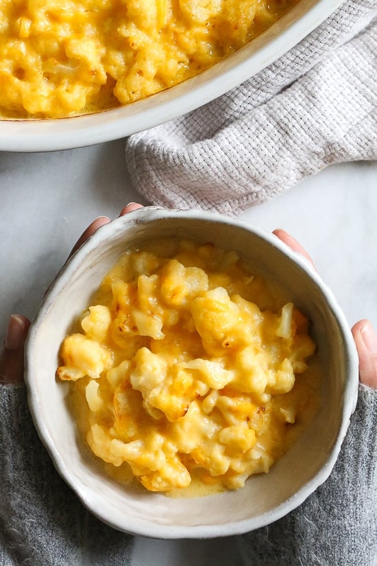 Cheesy cauliflower mac and cheese is perfect when you're craving macaroni and cheese, without the pasta. Each serving is loaded with veggies! Overhead view of a bowl of cauliflower mac and cheese.