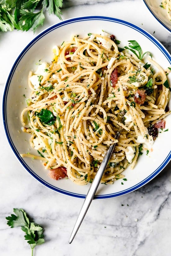 With diced bacon, grated cheese, black pepper, and a poached egg, this Spaghetti Carbonara is simple yet elegant. Overhead view of a plate of spaghetti carbonara