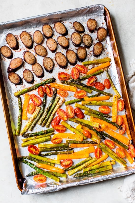 Kielbasa Veggie Sheet Pan Dinner is made with turkey kielbasa, asparagus, tomatoes and bell peppers cooked all on one pan, easy cleanup! It's also Keto, Whole30, Low Carb and Gluten-free.