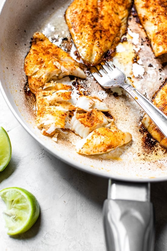 cod fish cooked in a skillet to make tacos