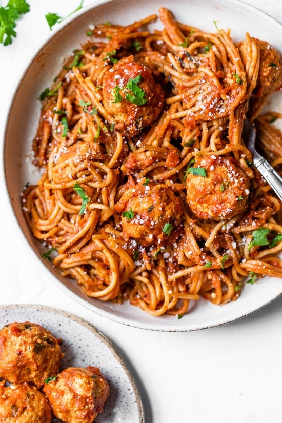 This healthy Instant Pot spaghetti and meatballs is made in one pot with juicy turkey meatballs, homemade marinara and whole wheat pasta. Bowl of Instant Pot spaghetti and meatballs.