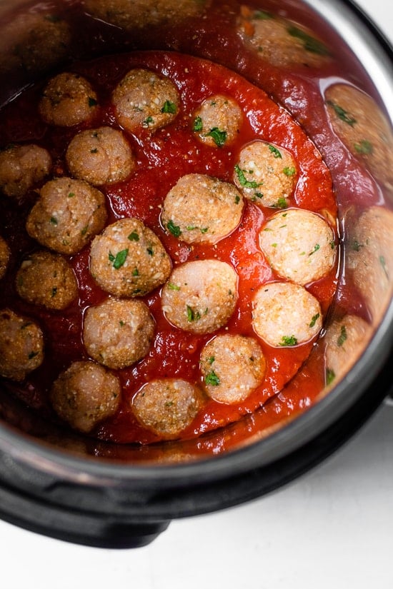 This healthy Instant Pot spaghetti and meatballs is made in one pot with juicy turkey meatballs, homemade marinara and whole wheat pasta. Meatballs in marinara sauce in instant pot.