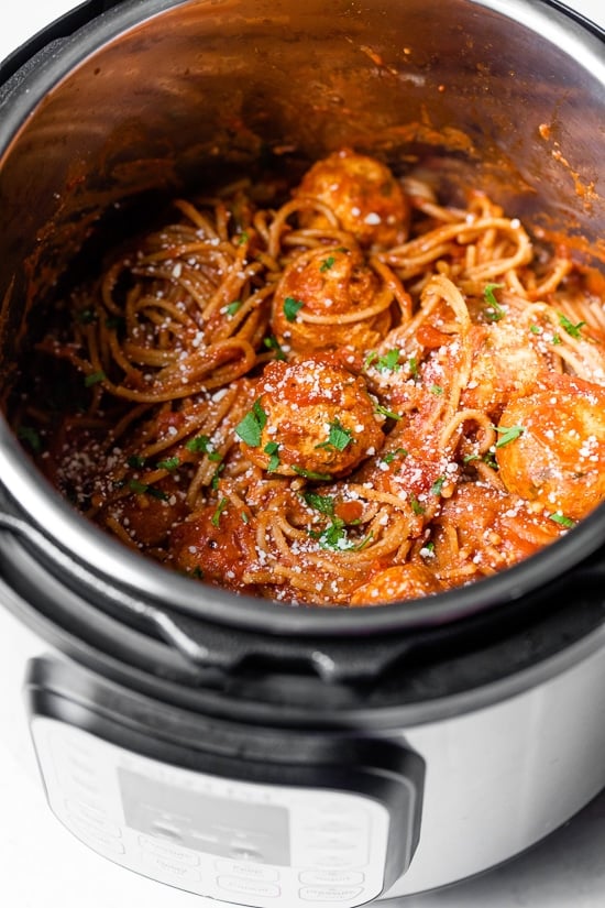 This healthy Instant Pot spaghetti and meatballs is made in one pot with juicy turkey meatballs, homemade marinara and whole wheat pasta. Spaghetti and meatballs in Instant Pot.
