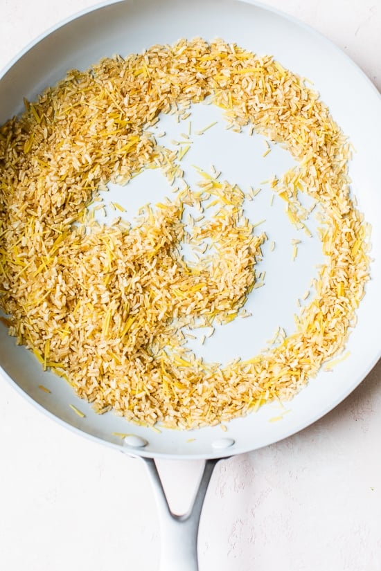 This homemade Rice-a-Roni style rice pilaf is made with toasted pasta, brown rice, and broth for an easy, buttery, family-friendly side dish. Toasting rice and pasta in a skillet.