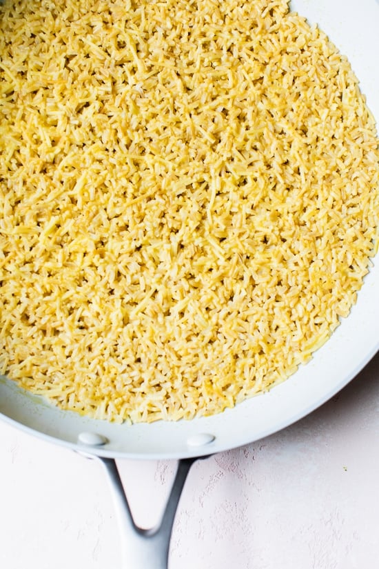 This homemade Rice-a-Roni style rice pilaf is made with toasted pasta, brown rice, and broth for an easy, buttery, family-friendly side dish. Rice pilaf in skillet.