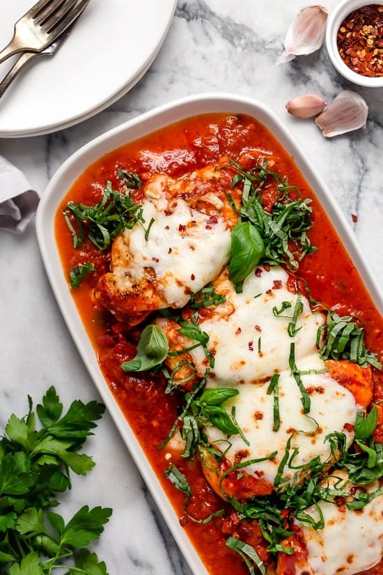 This quick and easy Instant Pot Chicken Parmesan is ready in minutes, with no breading or frying. Perfect for busy weeknights! Overhead view of instant pot chicken parmesan in a dish