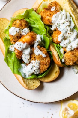 Crispy air fryer shrimp served on a soft potato bun with lettuce and homemade tartar sauce is the perfect summer sandwich.