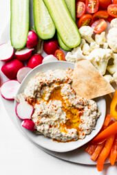 Platter with raw vegetables and bowl of baba ganoush.