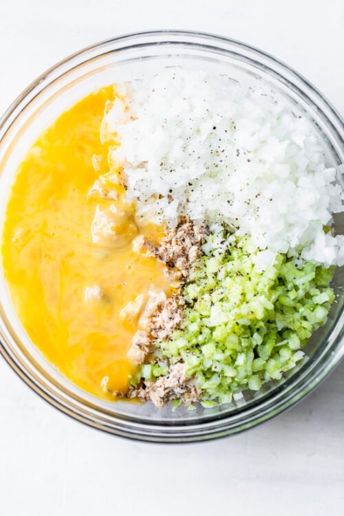 salmon, onion, celery and egg in a bowl