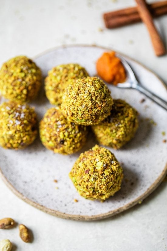 Pumpkin Pistachio Energy Balls piled on a plate