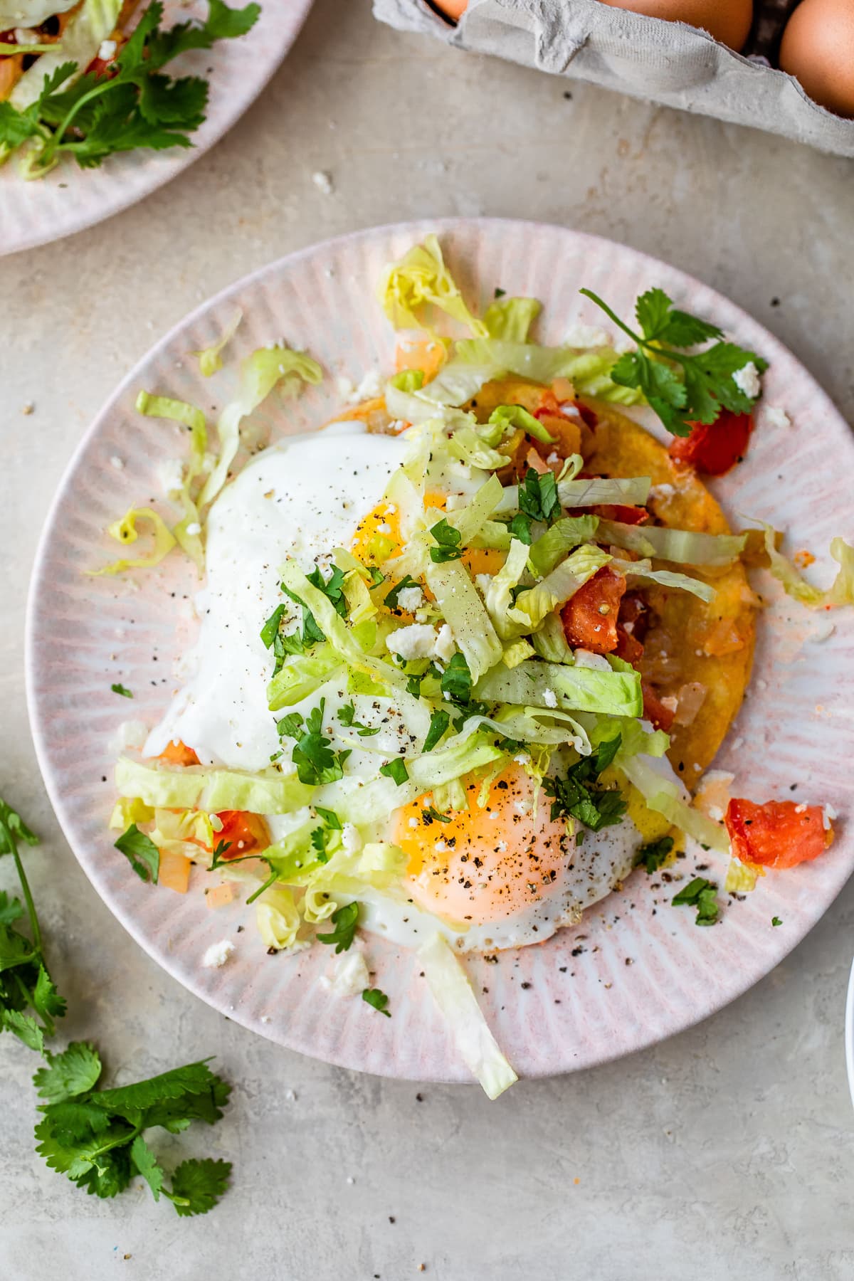 corn tortillas topped with fried eggs and salsa