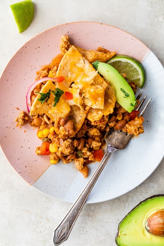 Dish with turkey taco meat, chips, avocado.