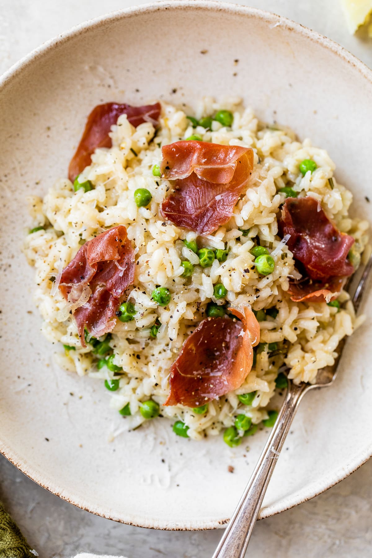 This Instant Pot Risotto recipe is the quickest, easiest way to make risotto. Perfectly creamy every time and it's ready in just 20 minutes. Overhead view of a bowl of Instant Pot Risotto with prosciutto