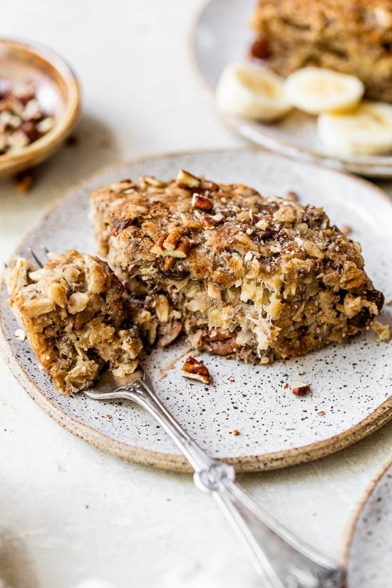 Banana Bread Baked Oatmeal in the Instant Pot? Yes! This oatmeal bars recipe makes an easy breakfast, brunch, or snack. Instant Pot Baked Oatmeal on a plate with a fork