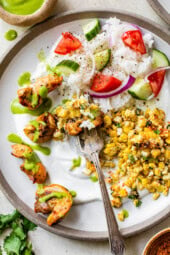 peruvian chicken on plate with rice and corn