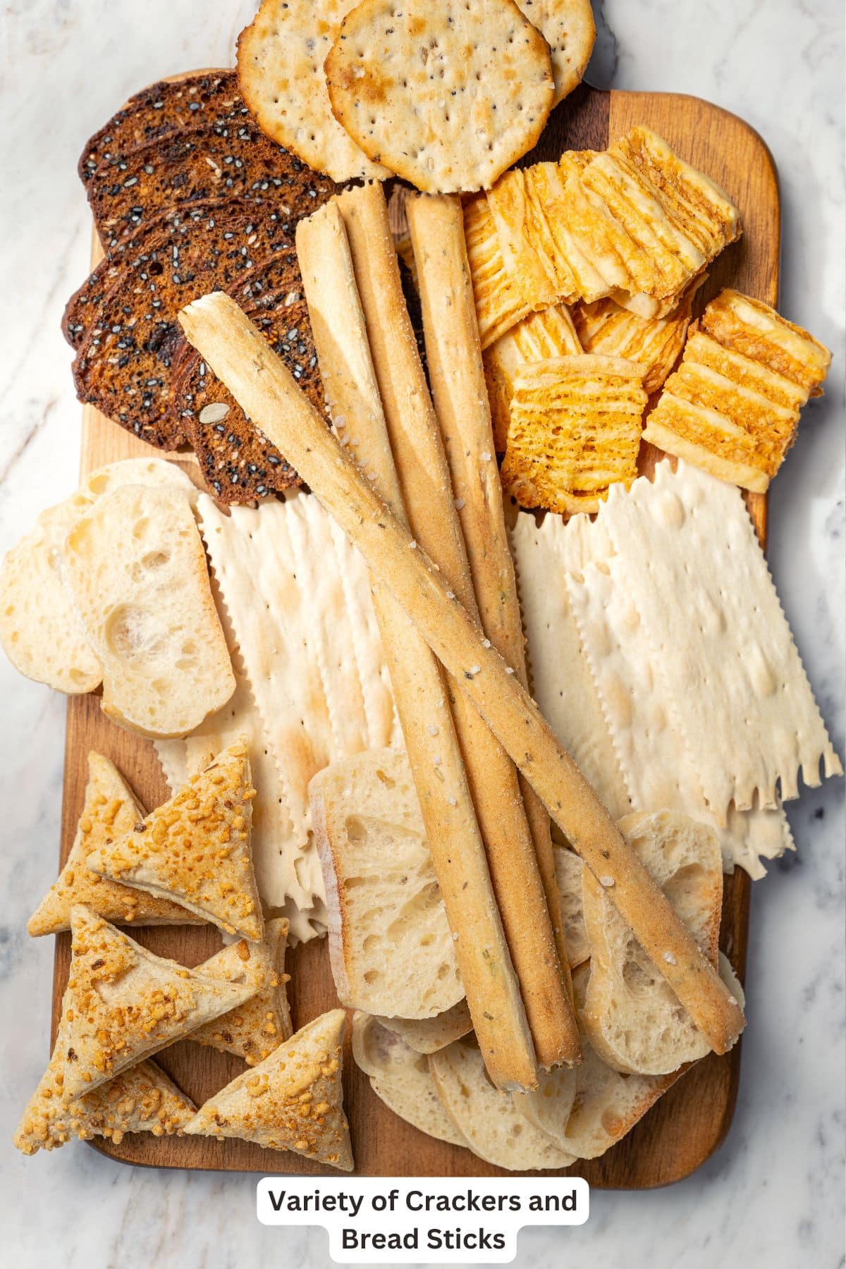 Your ultimate guide to creating a charcuterie and cheese board! I'll show you how to choose and arrange everything for a beautiful spread. Crackers and bread sticks for charcuterie board.