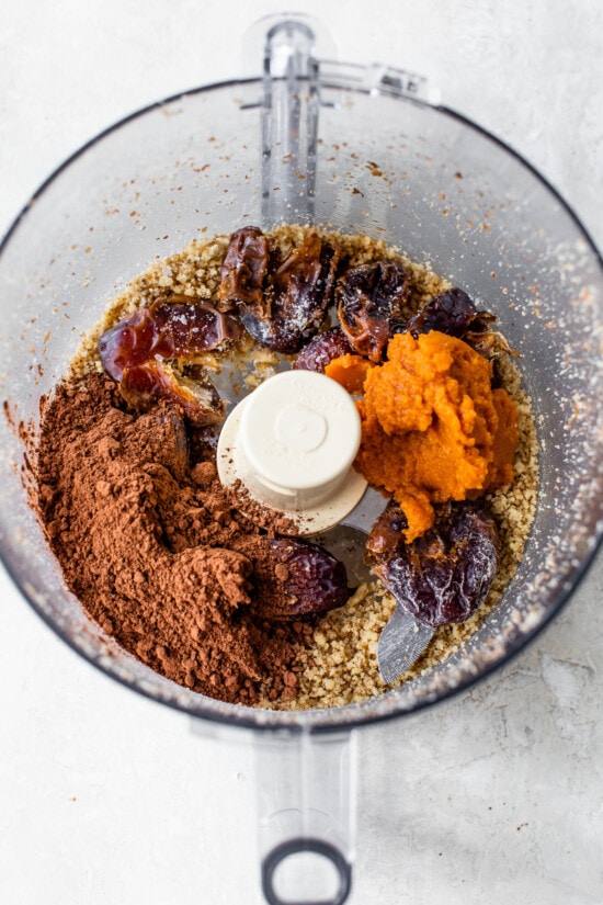 Made with Medjool dates, pumpkin, and cocoa powder, these Chocolate Date Balls taste just like a brownie! No bake & easy! dates and chocolate in a food processor