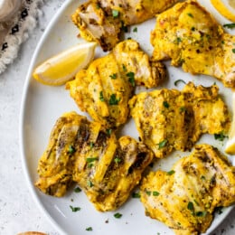 platter of grilled chicken thighs