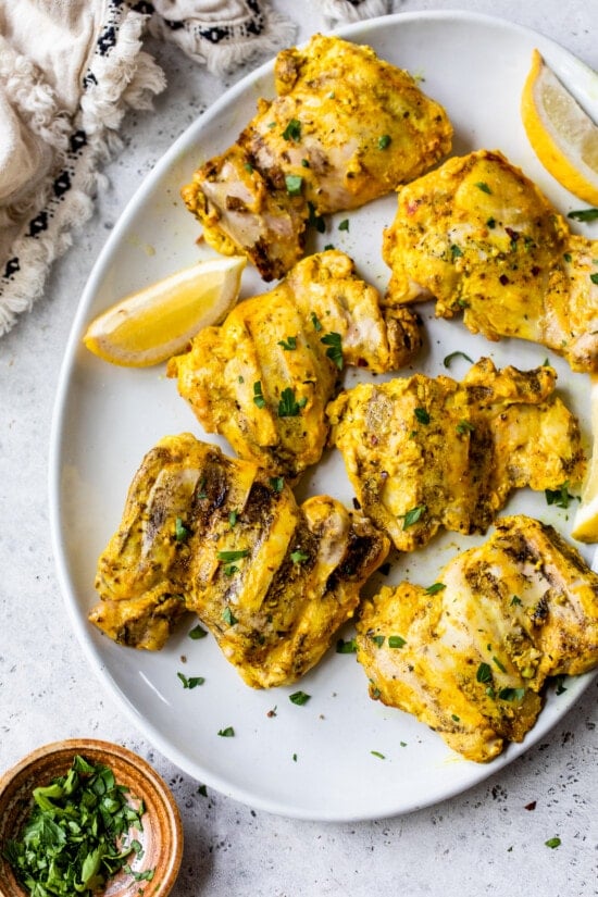 platter of grilled chicken thighs
