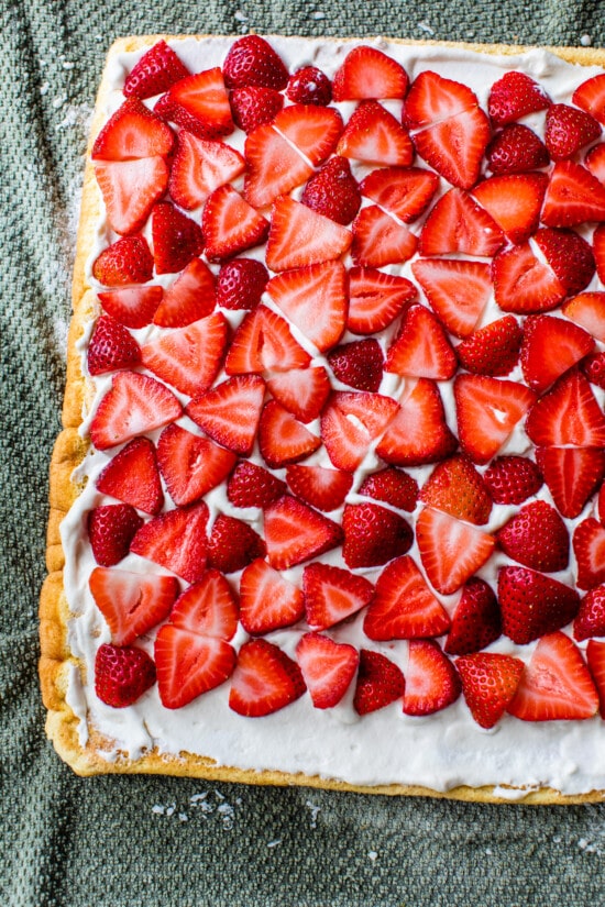 This Strawberry Swiss Roll features a soft sponge cake, sweet cream, and fresh strawberries. So simple & perfect when berries are in season. sponge cake topped with whipped cream and strawberries