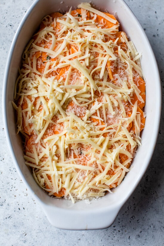 Make sweet potatoes au gratin inspired by Pommes Anna, a French dish of creamy, thinly sliced potatoes topped with melted Gruyere cheese. Layered sweet potato slices topped with shredded gruyere cheese.