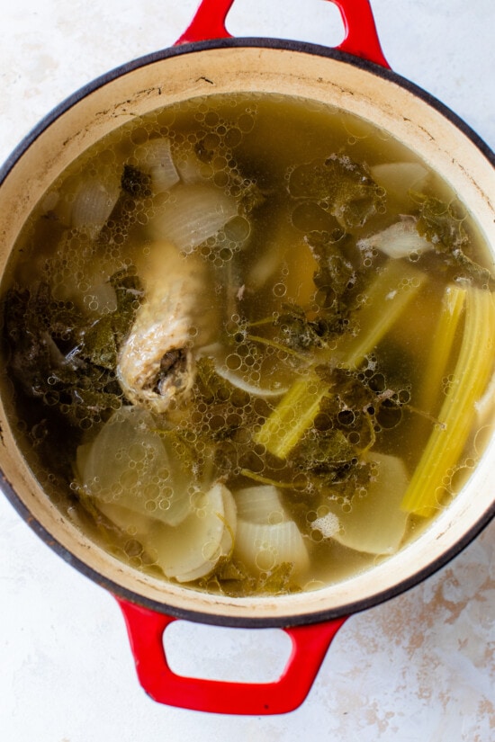 Made with just a handful of ingredients, this rich and flavorful Turkey Stock recipe is the secret to creating a memorable turkey gravy. turkey stock in pot