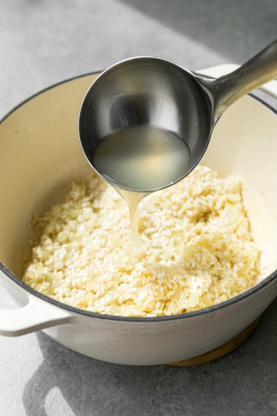 add broth to risotto