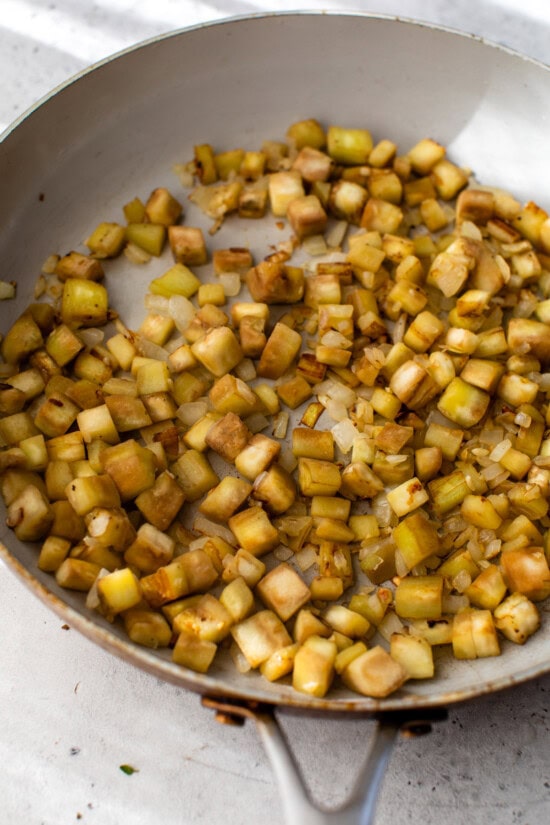 This easy ratatouille recipe is the perfect summer side dish for your favorite roasted chicken, grilled meats, or fish! Eggplant cooking in a skillet.
