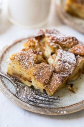 A slice of overnight creme brulee French toast on a plate with a fork.