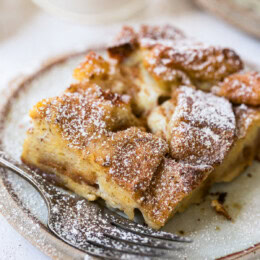 A slice of overnight creme brulee French toast on a plate with a fork.