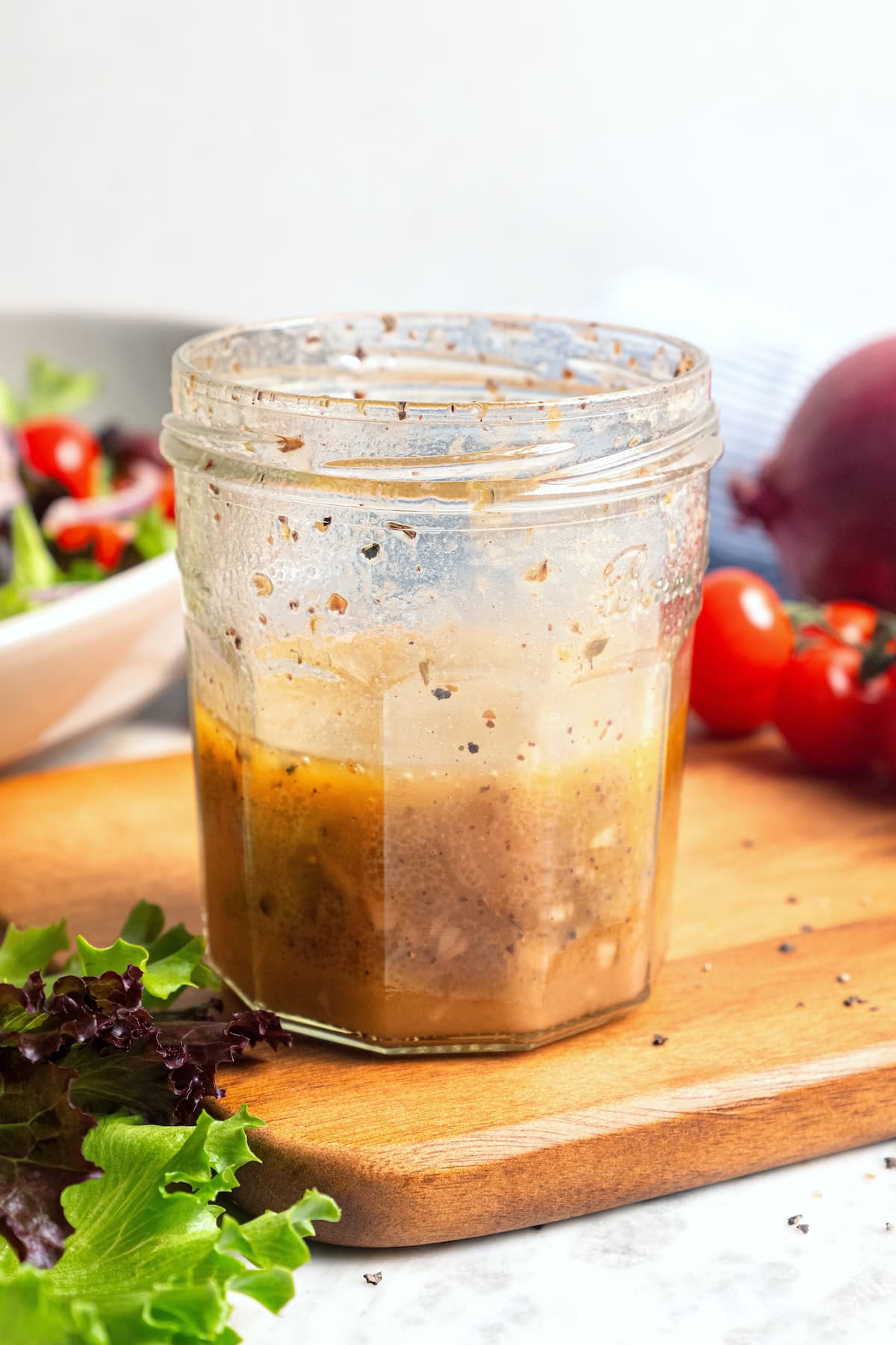 This homemade Greek salad dressing recipe blends simple pantry ingredients into a bright, zippy dressing you’ll want to pour on everything! Jar of Greek salad dressing.